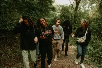 Flagler College students walking down a path through woods