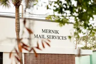 'Mernik Mail Services' building sign