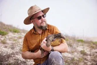 Ben Atkinson holding a turtle