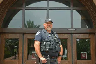Officer Gary Johnson in front of Proctor