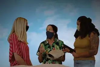 Three women are talking together.