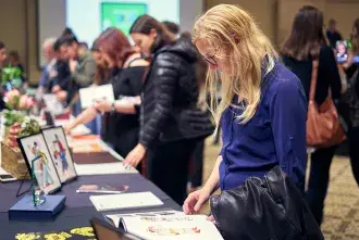 A student looks at a book of designs.