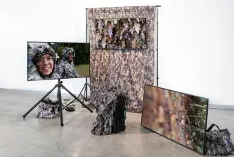 Bad Outdoorsmen: Katie HArgrave and Meredith Laura Lynn - image includes tv screens and backdrops with leaves