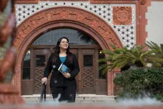 Sana Mohtasebzada walking through the courtyard of Ponce