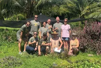 Matthew Murasko poses with a group in Hawaii