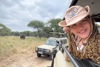 Nateleigh Nachreiner on Safari in Tanzania - head out the window of jeep