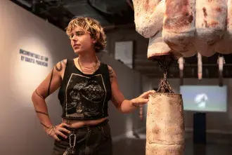 Ceam Artist in gallery with artwork