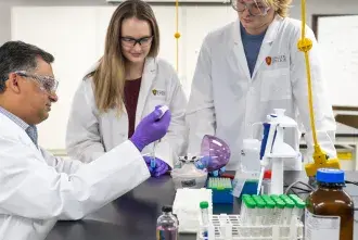 Professor with students in lab