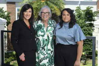 Laura Moody, Anila Lahiri, and Janet English stand beside eachother for a posed photo