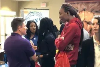 Student chatting with employer