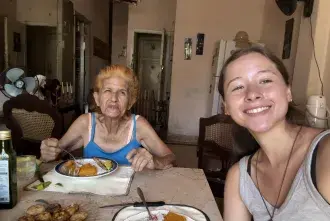 Sophia Cardona sits with an elderly Cuban woman