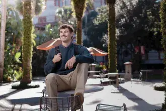 Environmental Science student Pasquale Arnone smiling and sitting on a table