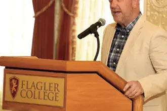 Art Vanden Houten standing at the podium in the Flagler Room