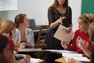 A Flagler College Professor teaching in the classroom