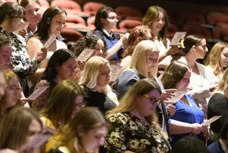 Students reading core value pledge at Baccalaureate 2022