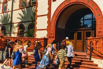Class of 2026 students entering proctor library