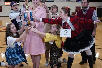 The cast of "The 25th Annual Putnam County Spelling Bee" poses together in the Flagler College Gymnasium