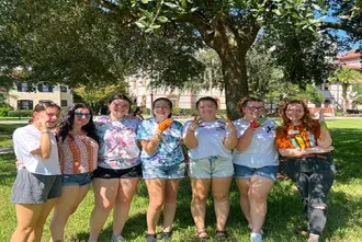Deaf Awareness Week Students on Lawn performing ASL