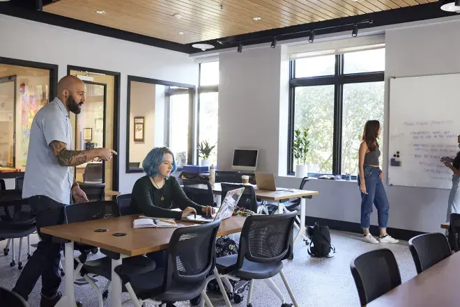 Students and faculty discussing academic topics in the Innovation Center