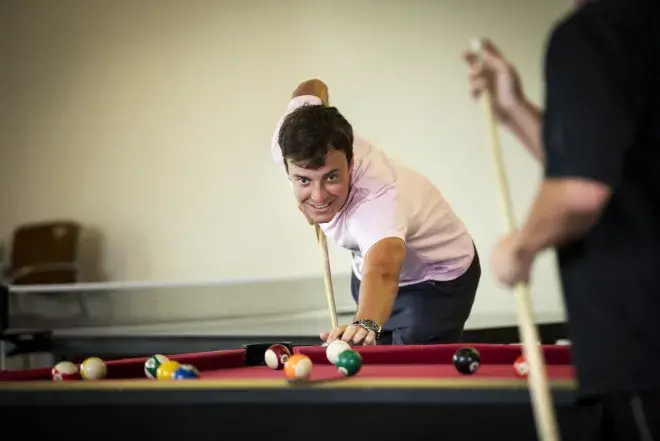 Student playing pool in the Ringhaver Student Center