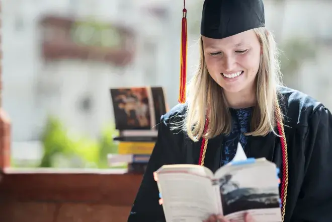 Ann reading a book smiling