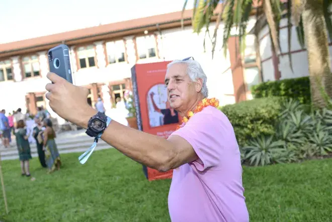 A Flagler College volunteer gestures across campus.