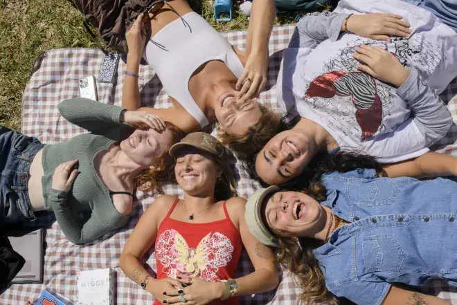 Flagler College students lay on a picnic blanket.