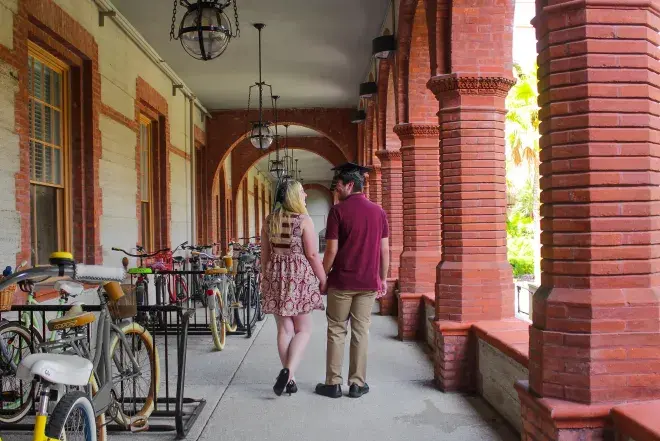 A couple walks on Flagler campus