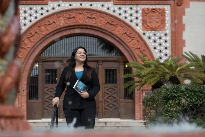 Sana Mohtasebzada walking through the courtyard of Ponce