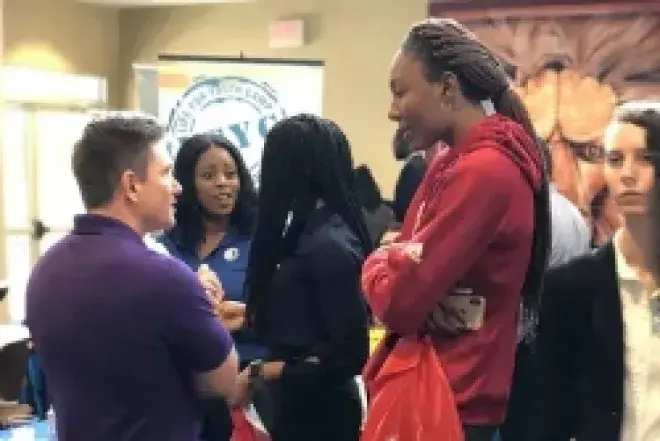 Student chatting with employer