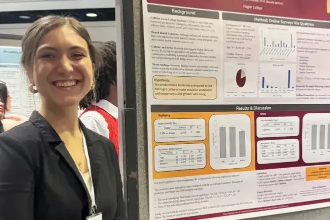 Student standing in front of research