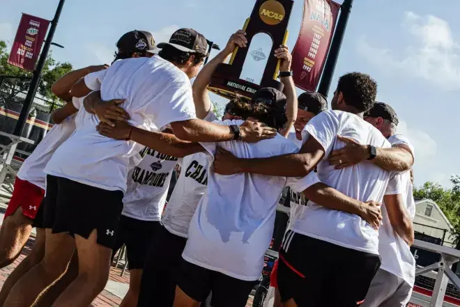 Men's tennis team holding trophy