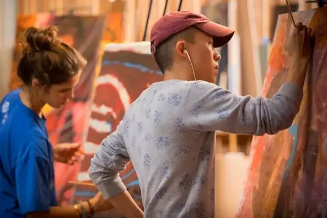 Students painting in classroom