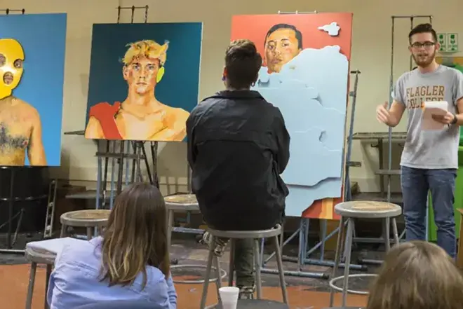 Student presenting artwork to class