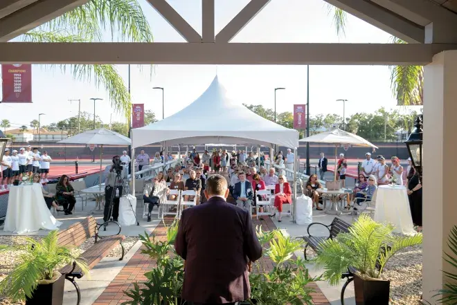 Wide shot of the dedication ceremony at the tennis courts