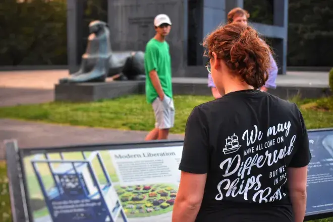 Student reading sign at historic park