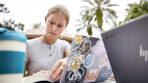 A Flagler College student reads intently.