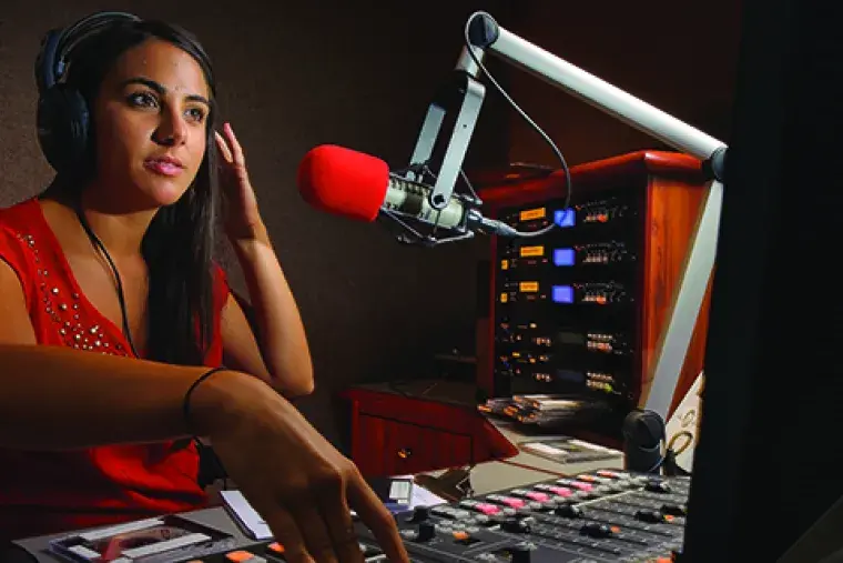 A student prepares to go on the air at WFCF, Flagler College's radio station.