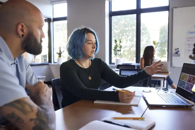 A Flagler College student talks with a faculty member.