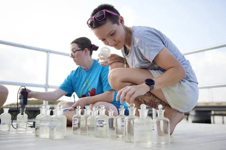 Two Flagler College students look at water samples.