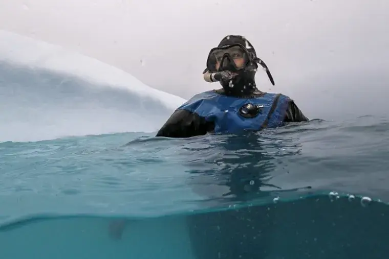 Claire Mortensen floating in the Arctic Sea in full scuba diving gear
