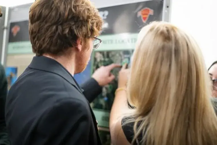 Image of students looking at project