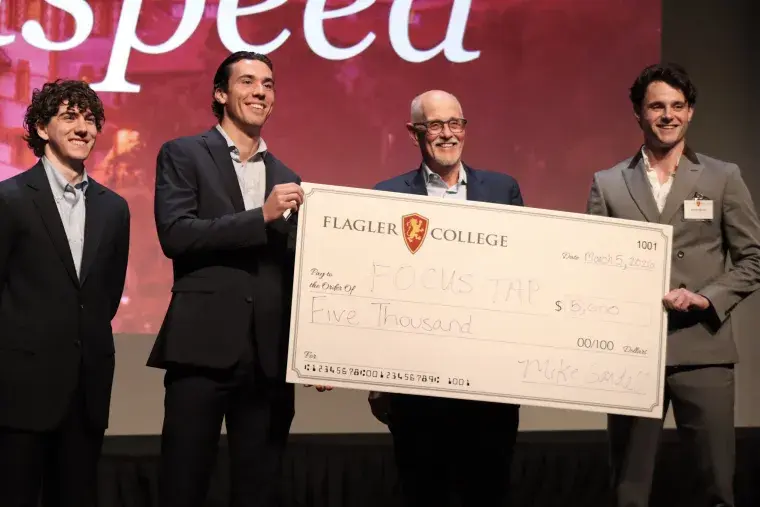 FocusTap student founders Jesse Van Krimpen and Reiss Skeen accept cash prize at Lion's Cage competition