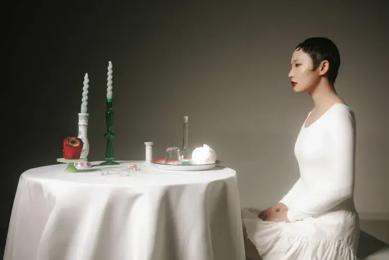 Juried Art Exhibit - Woman sitting at a table