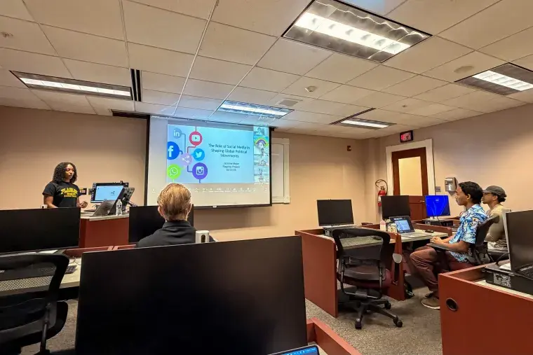Student Jazmine Major presents to her class in St Augustine, and virtually in China