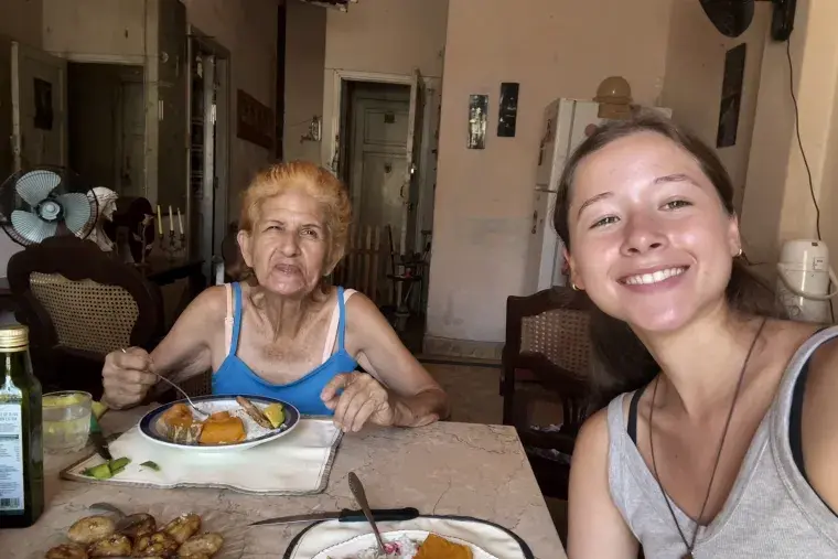 Sophia Cardona sits with an elderly Cuban woman