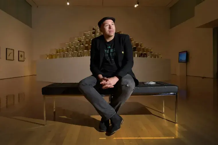 CEAM Artist Ballengee - Man sitting on a bench in an art gallery