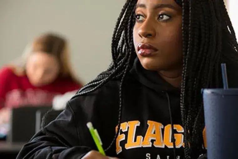 Sociology2.jpg Student listening attentively in classroom.