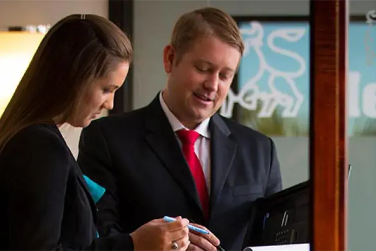 Business_Admin Hero.jpg Two businesspeople consult their notes together.
