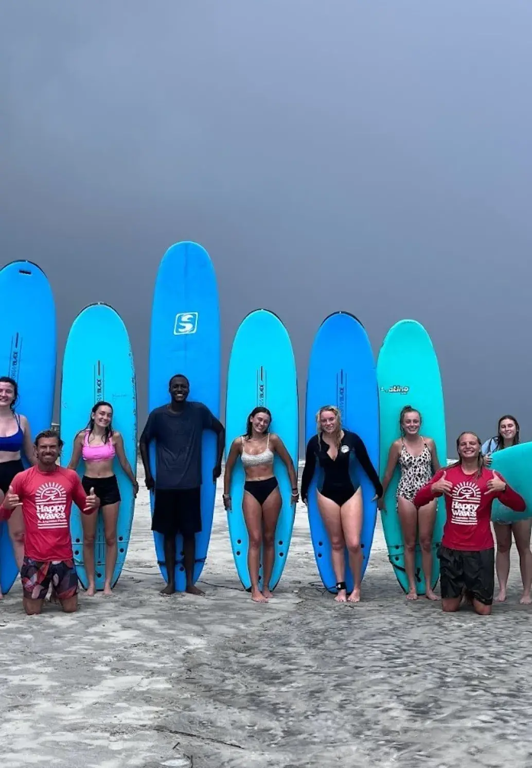Students standing in front of surf boards